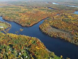 WS ARIEAL View of Small meandering river with wooded area / Maine, United States Stock Footage