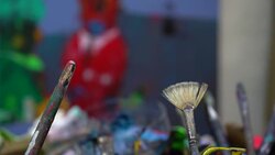 used paint brushes on a colorful painter palette Stock Footage