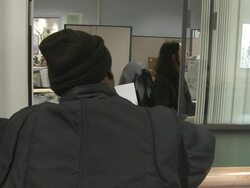 2009 MS Man in knit hat leaving counter in job center, clerk talking behind counter/ Antioch, California, USA/ AUDIO Stock Footage