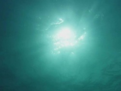 Low Angle hand-held - Sunlight creates a marble-like texture near the surface of the Coral Sea / Great Barrier Reef, Australia Stock Footage