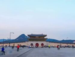 WS POV T/L Shot of Nightscape of Gwanghwamun ( main and largest gate of Gyeongbokgung Palace) crowded by pedestrians and traffic movings / Seoul, South Korea Stock Footage