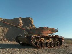 WS PAN Broken down tank in the desert Stock Footage