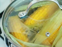 Corn cob boiling in a pot Stock Footage