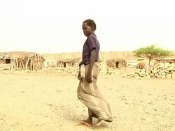 Boy who went through teeth ritual walking through village Stock Footage
