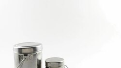 Tilt down to Set of Indian kitchen utensils in stainless steel in white isolated background Stock Footage