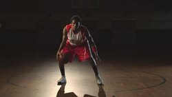 A male basketball player dribbles a ball in place. Stock Footage