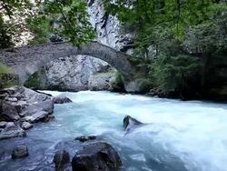 Mountain river with old bridge Stock Footage