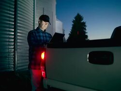 Farmer uses a digital tablet to access the internet Stock Footage
