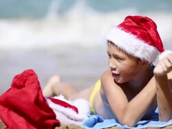 Boy Santa Claus resting on the sea Stock Footage