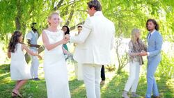 Bride and groom dancing at wedding reception in backyard Stock Footage