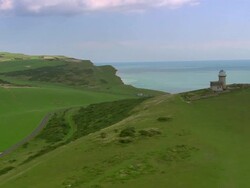 Aerial towards Belle Tout lighthouse off coast of English Channel / East Sussex, England Stock Footage