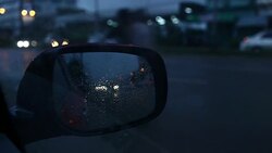 raindrops on mirror car Stock Footage