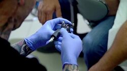 Tattoo artist preparing tattoo gun Stock Footage