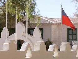 MS Shot of Church wall and flag waving with wind / San Pedro de Atacama, Norte Grande, Chile Stock Footage