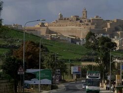 THE CITADEL VICTORIA AND DOUBLE DECKER TOURIST BUS Stock Footage