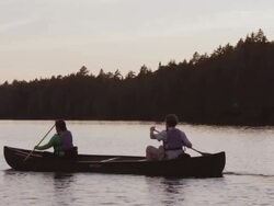 MS PAN Shot of Couple canoeing at sunset on Long Pond / Maine, United States Stock Footage