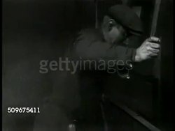 1940: SWEDEN: IRON ORE: EXPORT: LA WS Full railroad bin car, iron ore. HA WS Iron ore in railroad bin car moving down from loading dock. MINING: WS Blasting side of mountain, blast mining. Instructional Video