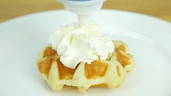 put whipping cream on top of the waffle. Front view. Slow motion. Stock Footage