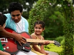 Man with his children playing a guitar  Stock Footage