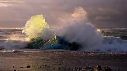 Iceberg on the black beach at dusk Stock Footage