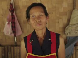 MS SLO MO Woman standing in front of bamboo wall  / Vang Vieng, Vientiane, Laos Stock Footage