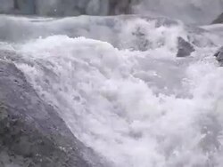 Medium Close Up static - Water cascades down a rocky stream bed / Alaska, USA Stock Footage