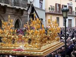 Costaleros bearing a Trono a religious float during Semana Santa, a procession through the streets of Malaga, Spain, Europe Stock Footage
