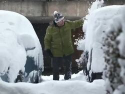 HD: Man Cleaning A Car Buried In Deep Snow Stock Footage