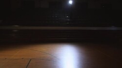 Widshot profile of male basketball player running up empty court to slam dunk (dolly w/ player) Stock Footage