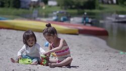 Sisters playing in the sand Stock Footage