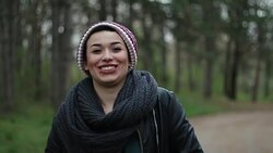 Adorable girl with an wide open smile walking in a park Stock Footage