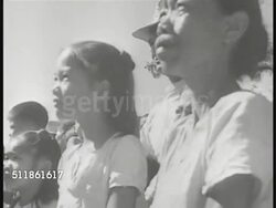 1941: JAPANESE FORCES IN PHILIPPINES: MS Loudspeaker w/ Japanese flag, brief SOT Japanese female speaking. VS Filipinos people handing Japanese propaganda flyers, leaflets to other Filipinos, children reaching out. Possibly Bataan province, WWII. Instructional Video