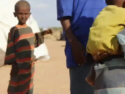 Boy carrying little child on his back Stock Footage