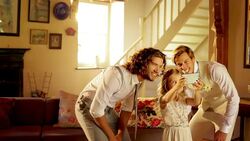 Groom taking selfie with groomsman and flower girl using camera phone Stock Footage