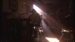 Sunlight filters into a 19th century tavern where a waiter serves two men at a table. Stock Footage