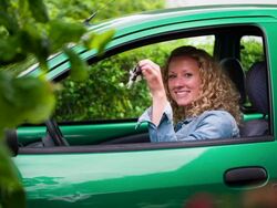 Woman in green car showing her car keys Stock Footage