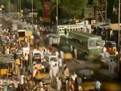 T/L MS High angle view of traffic and people moving through Indian city street, Madras Stock Footage