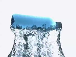 CU SLO MO Shot of Plastic Bottle of Water falling and Splashing against White Background / Calvados, Normandy, France Stock Footage