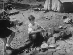 Scouts of France part 2 - boys prepare and eat dinner outdoors, write letters, sew socks, etc 1940s Stock Footage
