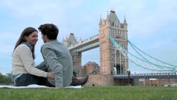 A couple share a romantic kiss near the Tower Bridge in London. Stock Footage