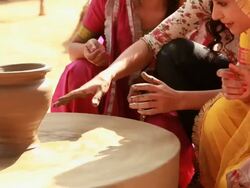 Three young women at pottery wheel in a village, Haryana, India Stock Footage