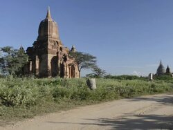 MS Shot of Horse carriage driving past Pagoda / Bagan, Mandalay Division, Myanmar Stock Footage