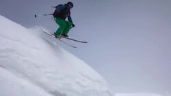 Skier skiing in fresh powder on a mountain. Stock Footage