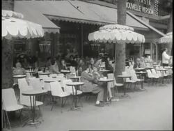 Traffic and pedestrians move near the Eiffel Tower and the Arc de Triomphe in Paris. News Clip