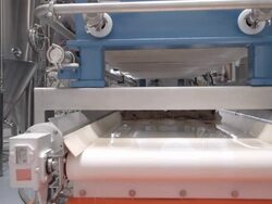 CU mash filter system conveyor belt drops chunks of spent grain into container / Thousand Palms, California, USA  Stock Footage