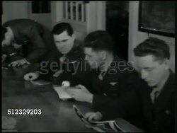 1942: U.S. AIR SQUADRON: RECONNAISSANCE CLASS: INT MS Instructor w/ airplane camera. MS Naval Air Force student pilots analyzing pictures. MS Instructor looking at aerial photograph on wall. VS Students w/ magnifying equipment looking at photos. Instructional Video
