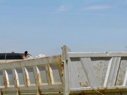 MS excavator loading material in dumper at deconstruction of bridge over river Mosel / Wellen, Rhineland Palatinate, Germany Stock Footage