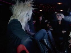 Medium shot pan glam band sitting in limo and talking Stock Footage