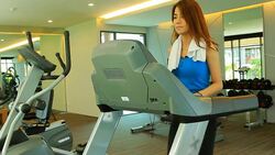 Beautiful woman walking on treadmill Stock Footage