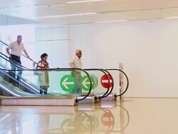 MS Shot of Passenger getting come down at escalator in Indira Gandhi International Airport / Delhi, India Stock Footage